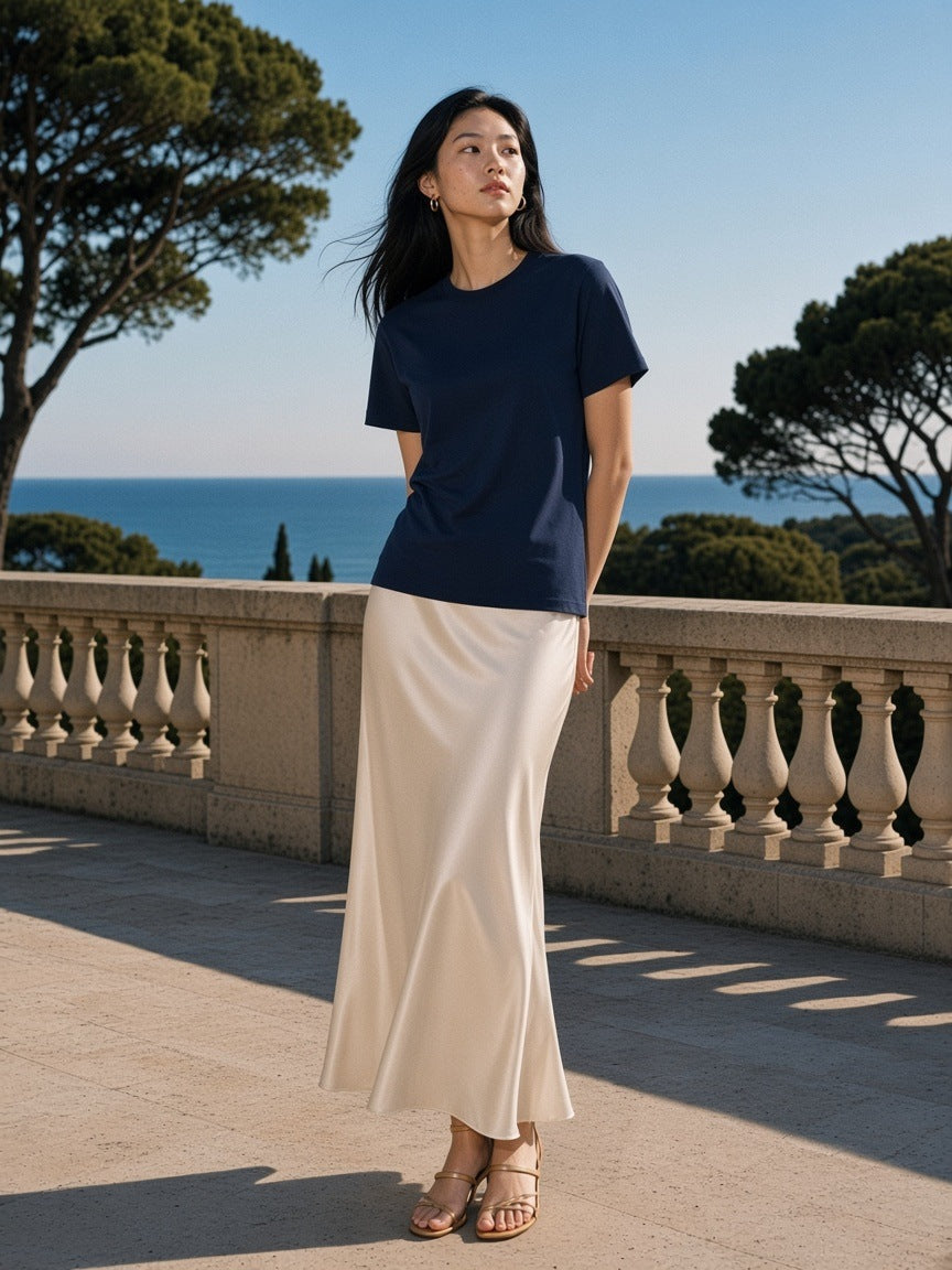 Woman in the Solid Color Regular Fit T-Shirt in Navy Blue, on a limestone hotel terrace in the morning on the French Riviera