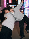 Man in the Waffle Boxy Full Zip Hoodie in Light Gray, collapsing into laughter with a friend in Shibuya at 2am