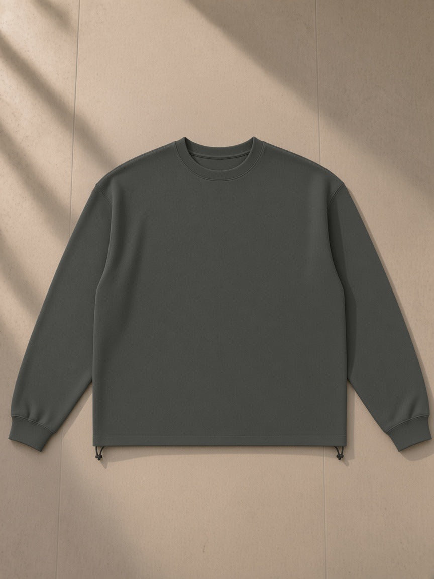 Heavyweight oversized boxy sweatshirt in Dark Gray, laid flat on pale limestone, front view