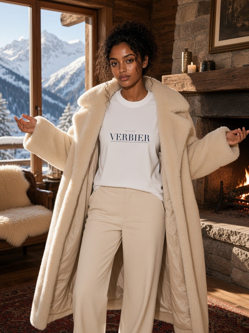 Woman in the Verbier Heavyweight Drop Shoulder T-Shirt in White in a chalet lobby in Verbier in the morning