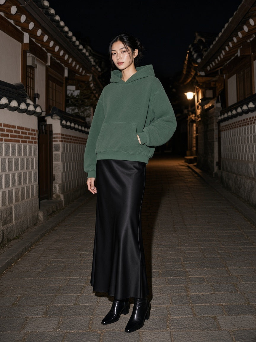 Woman in the vintage wash boxy fleece hoodie in Washed Green standing in a hanok lane in Bukchon, Seoul at night