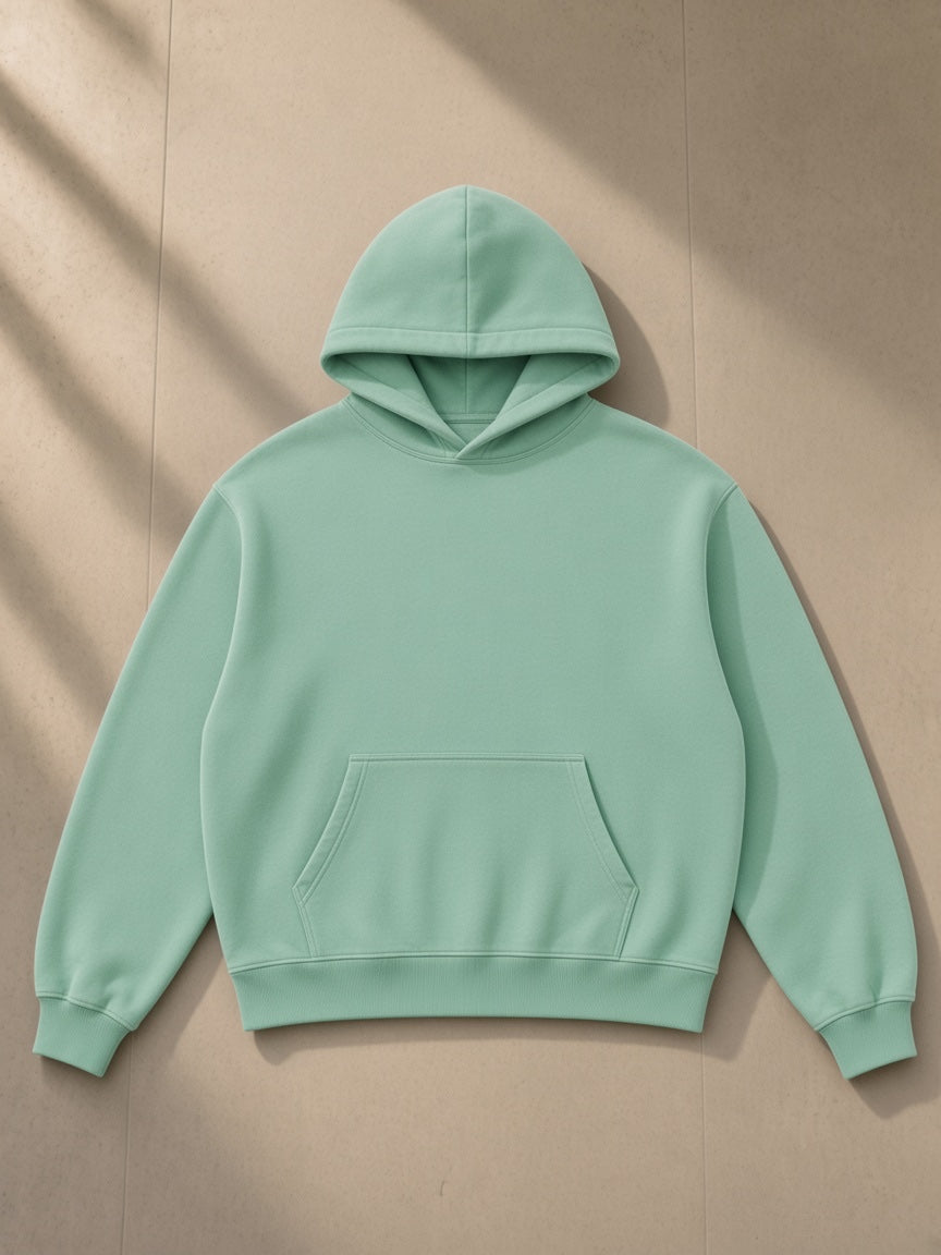 Vintage Wash Boxy Fleece Hoodie in Mint Green, laid flat on pale limestone, front view