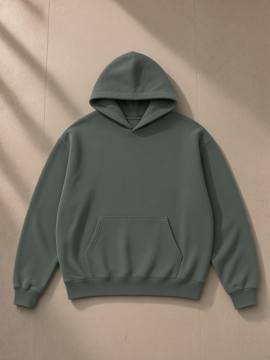 Vintage Wash Boxy Fleece Hoodie in Washed Green, laid flat on pale limestone, front view