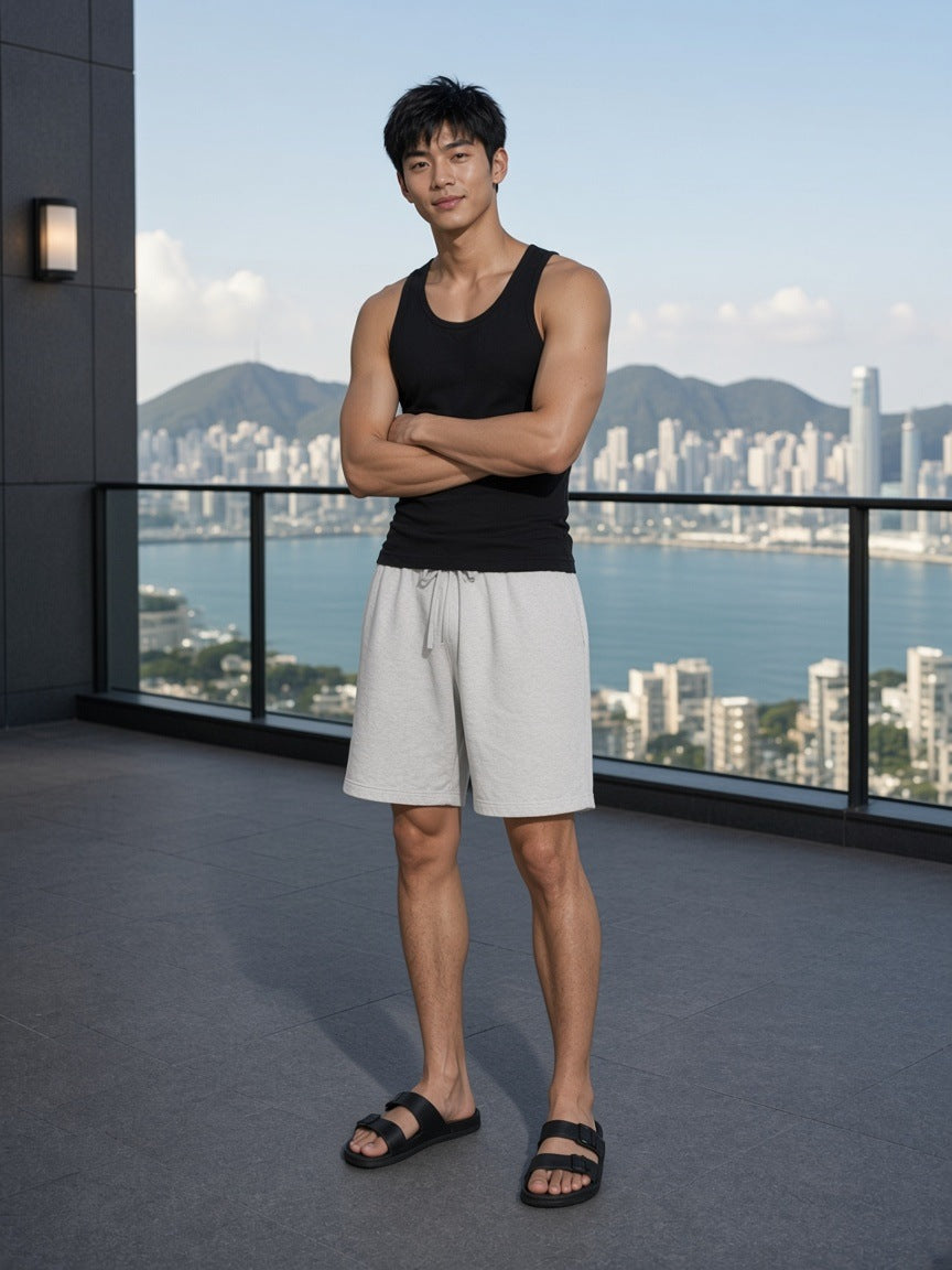 Man in the Vintage Wash Cotton Shorts in Greyish White on a penthouse terrace in Hong Kong by day
