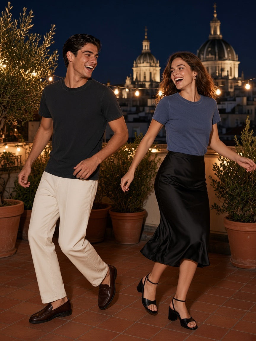 Two people in the Vintage Wash Slim Fit T-shirt in Black and Navy Blue dancing on a Madrid rooftop at night