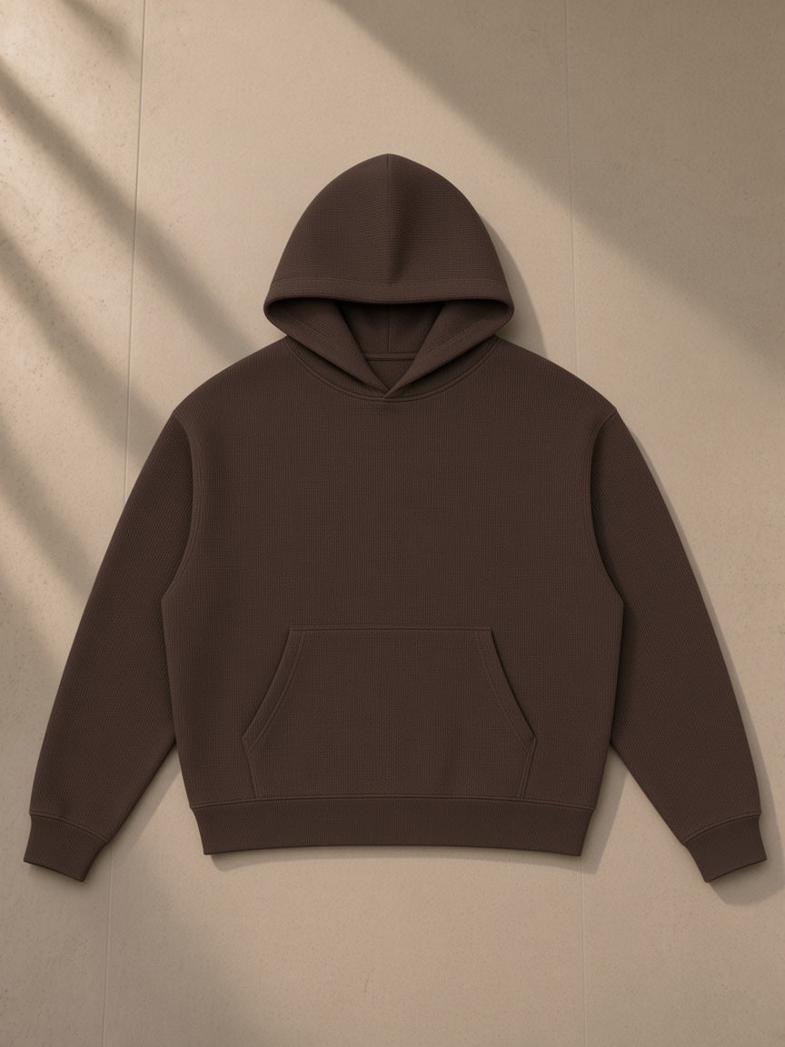 Waffle boxy hoodie in Coffee, laid flat on pale limestone, front view