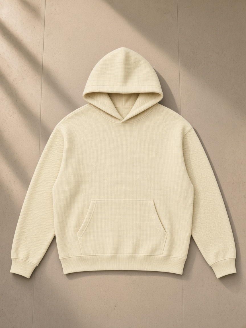 Waffle Hoodie in Mild Apricot, laid flat on pale limestone, front view