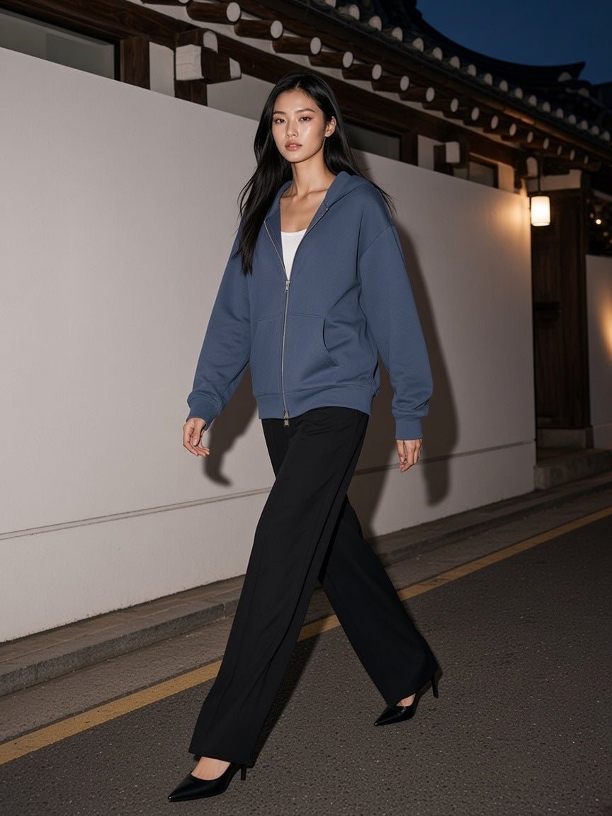 Woman in the Women's Drop Shoulder Full Zip Hoodie in Haze Blue walking a gallery street in Hannam-dong, Seoul at night