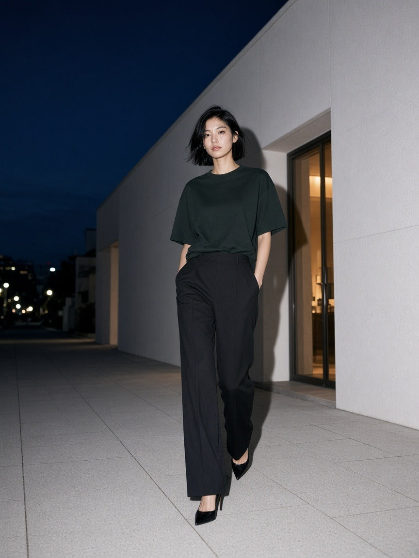 Woman in the Women's Heavyweight Boxy T-Shirt in Blackish Green walking a gallery street in Hannam-dong, Seoul at night