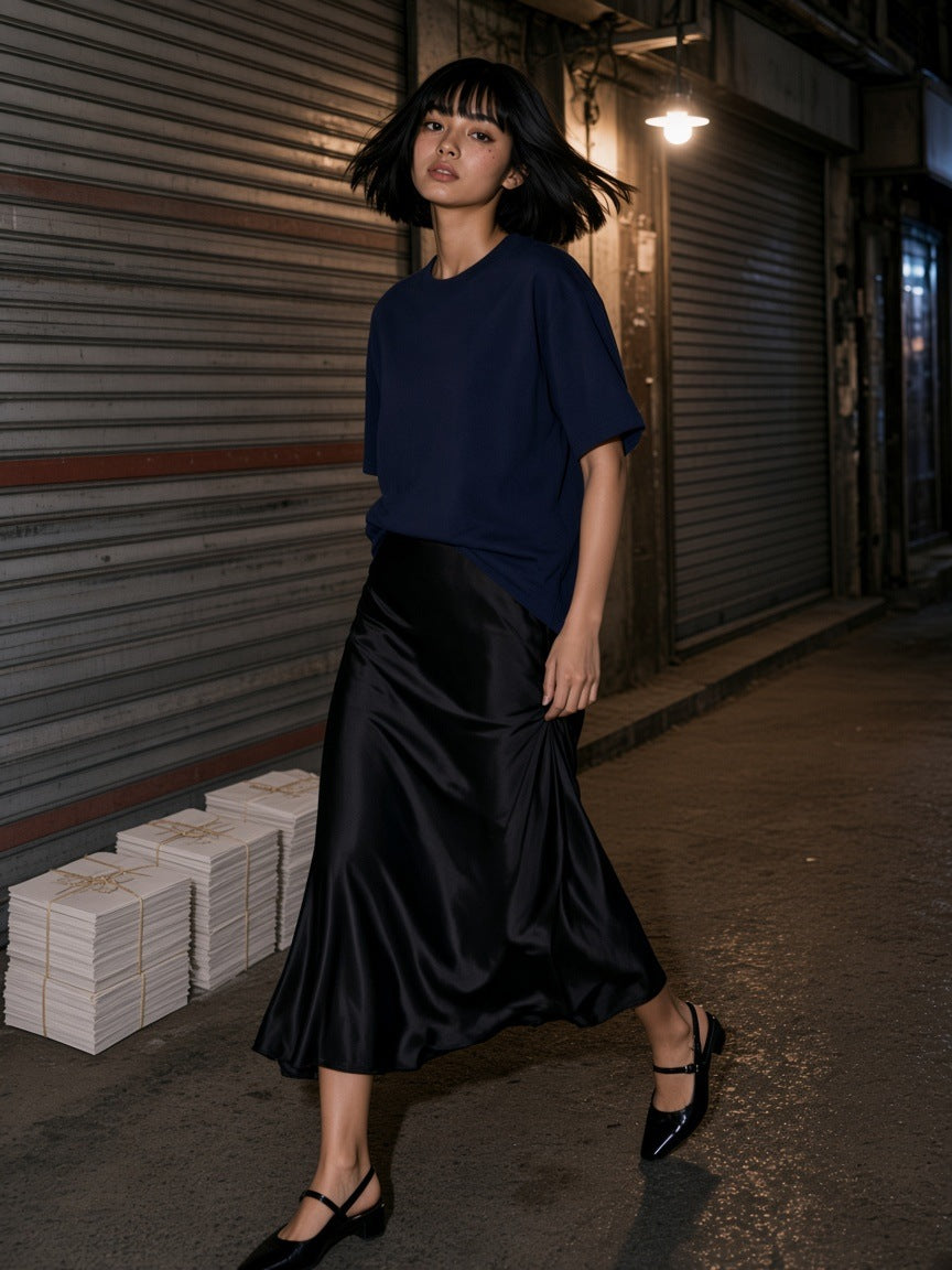 Woman in the Women's Oversized T-Shirt in Navy Blue turning in a print-shop lane in Euljiro, Seoul at night
