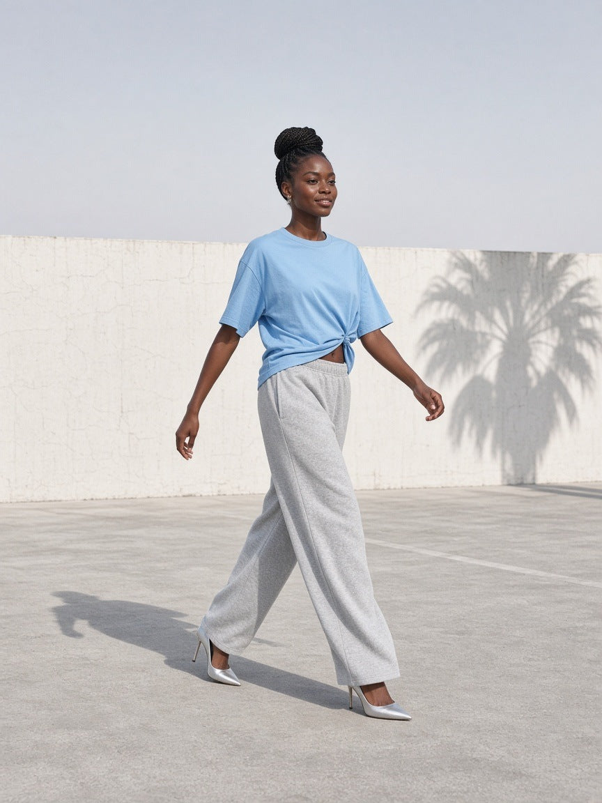 Woman in the Women's Oversized T-Shirt in Sky Blue on a white concrete rooftop in Los Angeles at morning