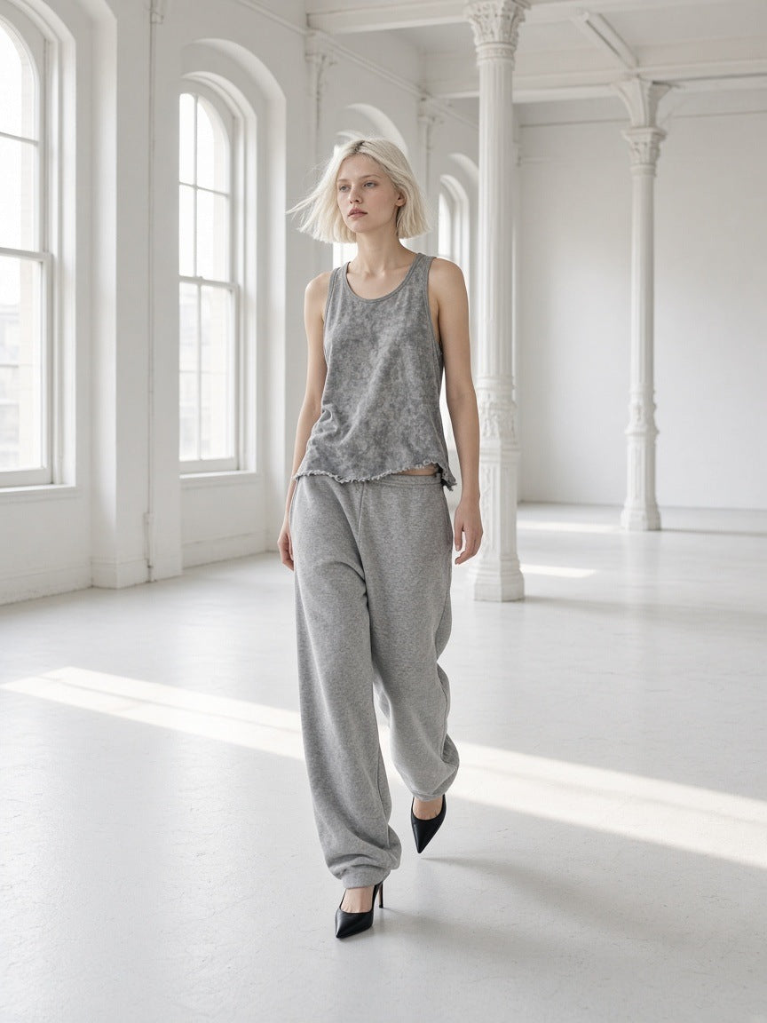 Woman in the Women's Snow Washed Frayed Hem Tank Top in Light Gray in a cast-iron loft in New York at morning