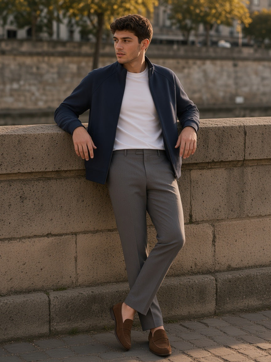 Man in a Navy Blue zip-pocket stand collar jacket over a white tee on a Seine quay at golden hour