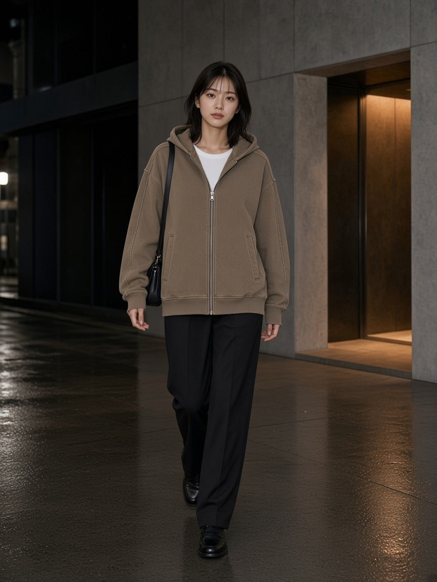 Woman in the Snow Washed Tape Raw Edge Zip Hoodie in Khaki walking an Omotesando side street in Tokyo at night